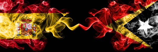 Spain vs East Timor smoky mystic flags placed side by side. Thick colored silky smokes flag of Spanish and East Timor — Stock Photo, Image