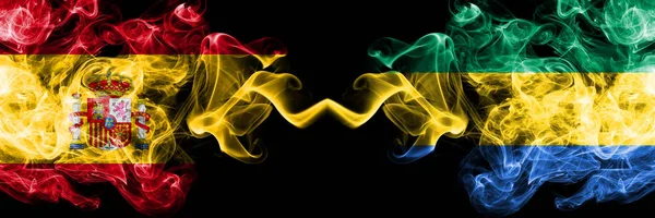 Spain vs Gabon, Gabonese smoky mystic flags placed side by side. Thick colored silky smokes flag of Spanish and Gabon, Gabonese — Stock Photo, Image