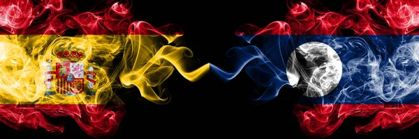 Spain vs Laos smoky mystic flags placed side by side. Thick colored silky smokes flag of Spanish and Laos — Stock Photo, Image