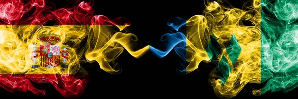 Spain vs Saint Vincent and the Grenadines smoky mystic flags placed side by side. Thick colored silky smokes flag of Spanish and Saint Vincent and the Grenadines — Stock Photo, Image