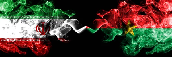 Iran vs Burkina Faso smoky mystic states flags placed side by side. Thick colored silky smokes flag combination of Iranian and Burkina Faso — Stock Photo, Image