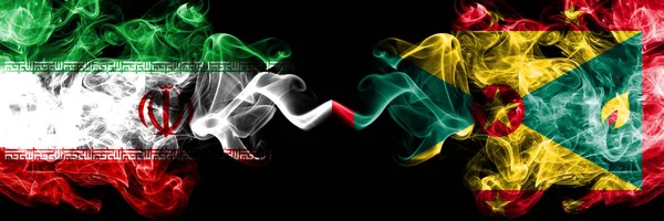 Iran vs Grenada smoky mystic states flags placed side by side. Thick colored silky smokes flag combination of Iranian and Grenada — Stock Photo, Image