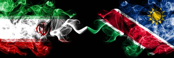 Iran VS Namibië, Namibische Smoky Mystic Staten vlaggen naast elkaar geplaatst. Dikke gekleurde zijdeachtige rookt vlag combinatie van Iraanse en Namibië, Namibische — Stockfoto