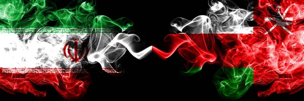 Iran vs Oman, Omani smoky mystic states flags placed side by side. Thick colored silky smokes flag combination of Iranian and Oman, Omani — Stock Photo, Image