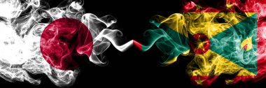 Japonya vs Grenada dumanlı mistik bayraklar yan yana yerleştirilir. Grenada ve Japon bayrağı kalın renkli ipeksi dumanlar kombinasyonu