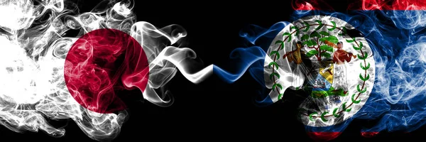 Japan vs Belize, Belizean smoky mystic flags placed side by side. Thick colored silky smokes combination of Belize, Belizean and Japanese flag — Stock Photo, Image