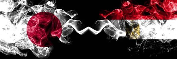 Japan vs Egypten, egyptiska rökig Mystic flaggor placerade sida vid sida. Tjocka färgade silkeslena röker kombination av Egypten, egyptiska och japanska flaggan — Stockfoto