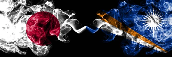 Japan vs Marshall Islands smoky mystic flags placed side by side. Thick colored silky smokes combination of Marshall Islands and Japanese flag — Stock Photo, Image