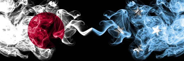 Japan vs Micronesia, Micronesian smoky mystic flags placed side by side. Thick colored silky smokes combination of Micronesia, Micronesian and Japanese flag — Stock Photo, Image