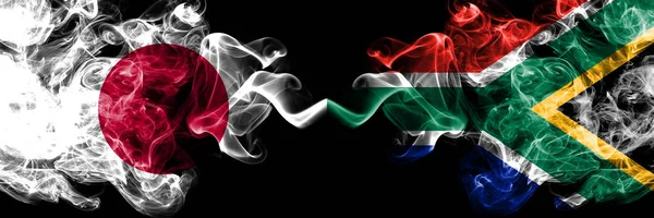 Japan VS Zuid-Afrika, Afrikaanse Smoky Mystic vlaggen geplaatst naast elkaar. Dikke gekleurde zijdeachtige rookt combinatie van Zuid-Afrika, Afrikaanse en Japanse vlag — Stockfoto