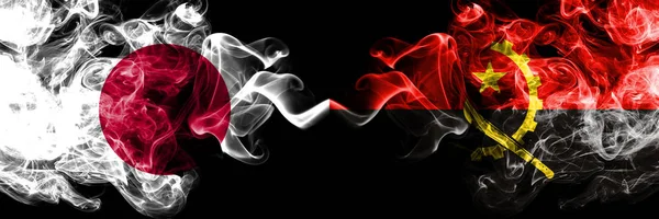 Japan vs Angola, Angolan smoky mystic flags placed side by side. Thick colored silky smokes combination of Angola, Angolan and Japanese flag — Stock Photo, Image