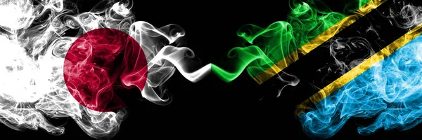 Japan vs Tanzania, Tanzanian smoky mystic flags placed side by side. Thick colored silky smokes combination of Tanzania, Tanzanian and Japanese flag — Stock Photo, Image