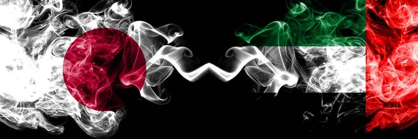 Japan vs United Arab Emirates, Emirati smoky mystic flags placed side by side. Thick colored silky smokes combination of United Arab Emirates, Emirati and Japanese flag — Stock Photo, Image