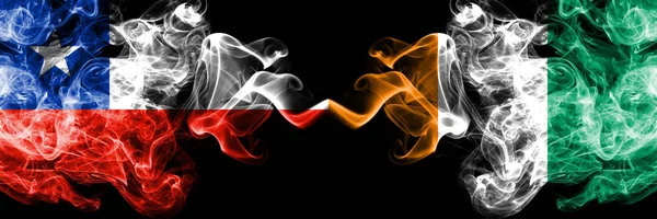 Chile vs Ivory Coast smoky mystic flags placed side by side. Thick colored silky smokes combination of Ivory Coast and Chilean flag — Stock Photo, Image