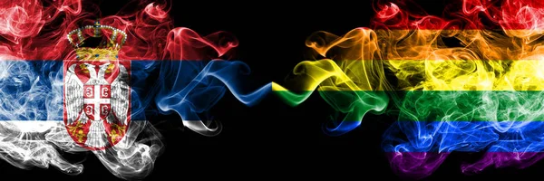 Serbia vs Gay pride smoky mystic flags placed side by side. Thick colored silky smokes combination of Serbian and Gay pride flag — Stock Photo, Image