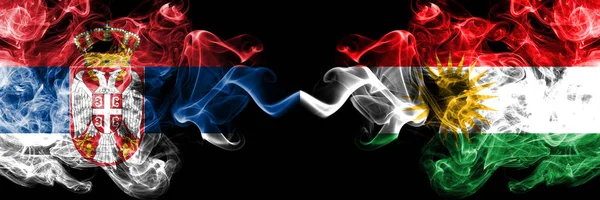 Serbia vs Kurdistan, Kurdish smoky mystic flags placed side by side. Thick colored silky smokes combination of Serbian and Kurdistan, Kurdish flag — Stock Photo, Image