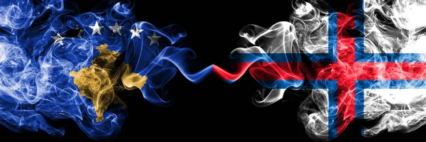 Kosovo vs Faroe Islands smoky mystic flags placed side by side. Thick colored silky smokes combination of Kosovo and Faroe Islands flag — Stock Photo, Image