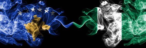 Kosovo vs Nigeria, Nigerian smoky mystic flags placed side by side. Thick colored silky smokes combination of Kosovo and Nigeria, Nigerian flag — Stock Photo, Image