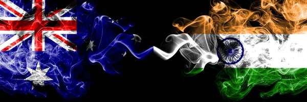 Australia vs India, banderas místicas indias colocadas una al lado de la otra. Color grueso sedoso humo combinación de banderas nacionales de Australia y la India, India — Foto de Stock