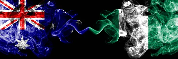 Australia vs Nigeria, Nigerian smoky mystic flags placed side by side. Thick colored silky smokes combination of national flags of Australia and Nigeria, Nigerian — Stock Photo, Image