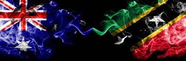 Avustralya vs Saint Kitts ve Nevis dumanlı mistik bayraklar yan yana yerleştirilir. Avustralya ve Saint Kitts ve Nevis ulusal bayrakları kalın renkli ipeksi dumanlar kombinasyonu