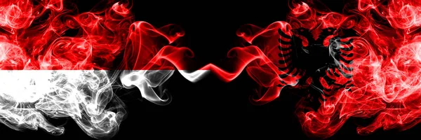 Indonesia vs Albania, Albanian smoky mystic flags placed side by side. Thick colored silky smoke flags of Indonesia and Albania, Albanian — Stock Photo, Image