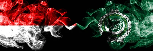 印尼队对阿拉伯联盟队，黑烟神秘的旗帜并排飘扬。印度尼西亚和阿拉伯联盟的厚彩色丝状烟旗 — 图库照片
