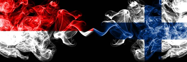 Indonesien vs Finland, finska rökiga mystiska flaggor placerade sida vid sida. Tjocka färgade silkeslena rök flaggor i Indonesien och Finland, finska — Stockfoto