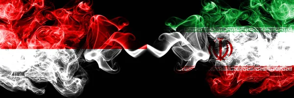 Indonesia vs Irán, banderas místicas humeantes iraníes colocadas lado a lado. Banderas de humo sedoso de color grueso de Indonesia e Irán, Irán — Foto de Stock