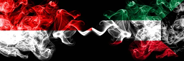 Indonesia vs Kuwait, Banderas místicas ahumadas kuwaitíes colocadas una al lado de la otra. Banderas de humo sedoso de colores gruesos de Indonesia y Kuwait, Kuwait —  Fotos de Stock