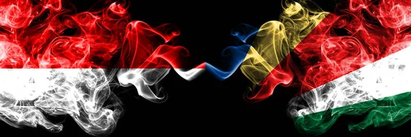 Indonezja vs Seszele, Seszelelloise smoky Mystic flagi umieszczone obok siebie. Grube kolorowe flagi dymu jedwabiste Indonezji i Seszeli, Seszelelloise — Zdjęcie stockowe