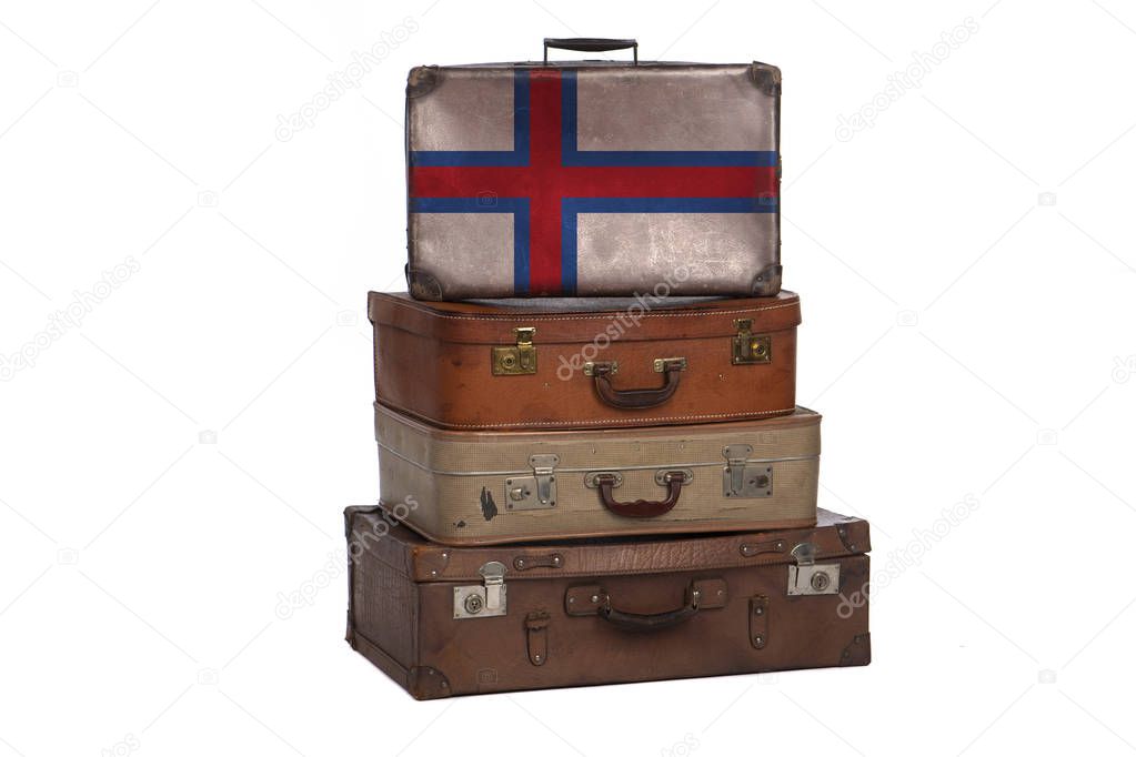 Faroe Islands travel concept. Group of vintage suitcases isolated on white background.