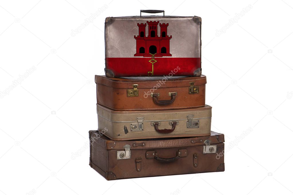Gibraltar travel concept. Group of vintage suitcases isolated on white background.