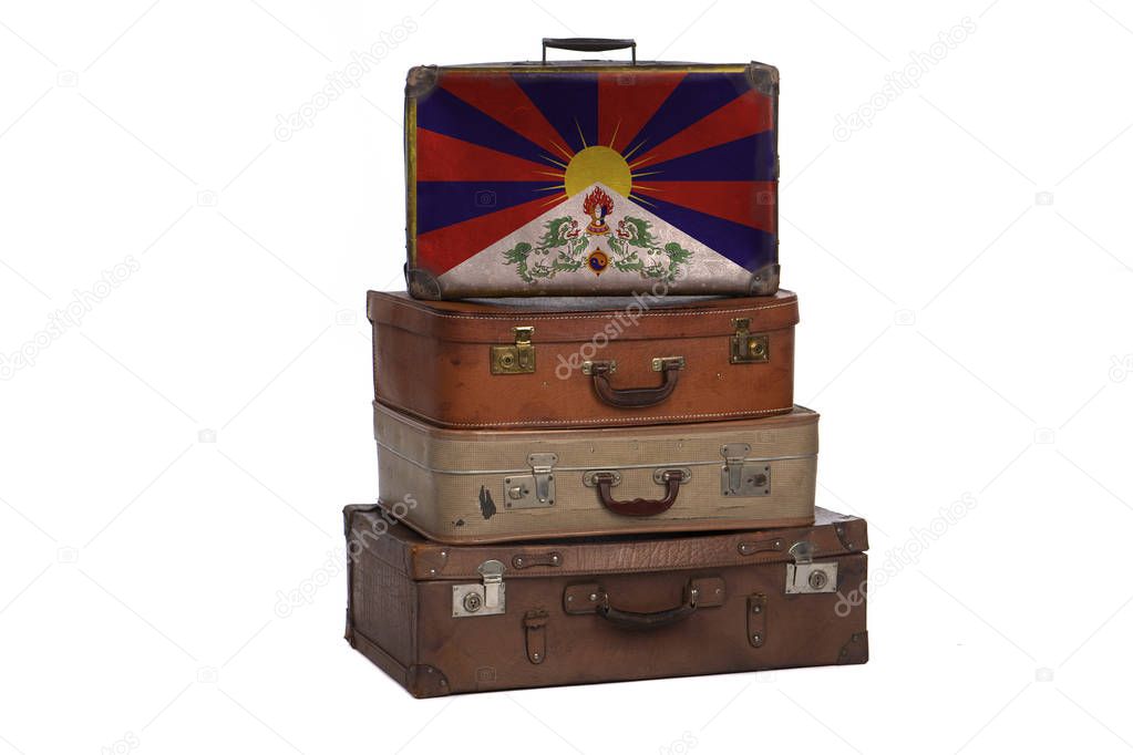 Tibet, Tibetan travel concept. Group of vintage suitcases isolated on white background.