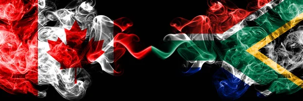 Canada vs South Africa, African smoky mystic flags placed side by side. Thick colored silky smoke flags of Canadian and South Africa, African. — Stock Photo, Image