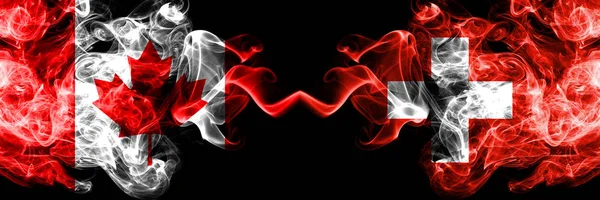 Canada vs Switzerland, Swiss smoky mystic flags placed side by side. Thick colored silky smoke flags of Canadian and Switzerland, Swiss. — Stock Photo, Image