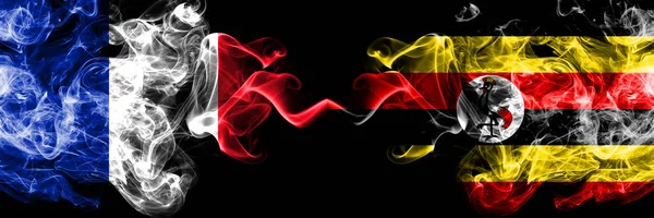 France vs Uganda, Ugandan smoky mystic flags placed side by side. Thick colored silky abstract smoke banner of French and Uganda, Ugandan — Stock Photo, Image