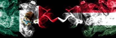 Meksika vs Macaristan, Macar dumanlı mistik bayraklar yan yana yerleştirilir. Kalın renkli ipeksi soyut Meksika ve Macaristan, Macar