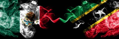Meksika vs Saint Kitts ve Nevis dumanlı mistik bayraklar yan yana yerleştirilir. Kalın renkli ipeksi soyut Meksika ve Saint Kitts ve Nevis ve afiş dumanlar