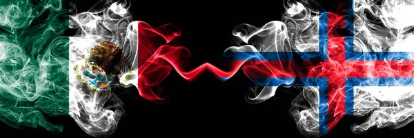 Mexico vs Faroe Islands smoky mystic flags placed side by side. Thick colored silky abstract smokes banner of Mexican and Faroe Islands — Stock Photo, Image