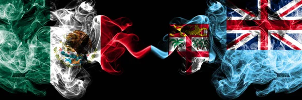 Meksika vs Fiji dumanlı mistik bayraklar yan yana yerleştirilir. Kalın renkli ipeksi soyut Meksika ve Fiji afiş dumanlar