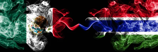 Meksika vs Gambiya, Gambiya dumanlı mistik bayraklar yan yana yerleştirilir. Kalın renkli ipeksi soyut Meksika ve Gambiya, Gambiya afiş dumanlar