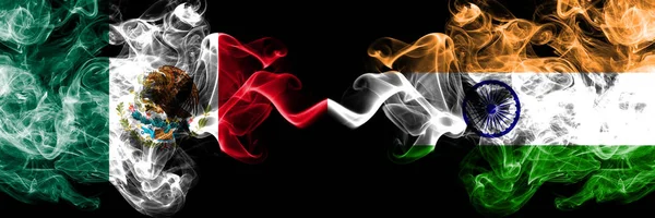 Mexico vs India, Indian smoky mystic flags placed side by side. Thick colored silky abstract smokes banner of Mexican and India, Indian