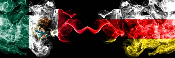 Mexico vs South Ossetia smoky mystic flags placed side by side. Thick colored silky abstract smokes banner of Mexican and South Ossetia — Stock Photo, Image