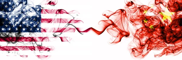 United States of America vs China, Chinese smoky mystic flags placed side by side. Thick colored silky abstract smokes banner of America and China, Chinese