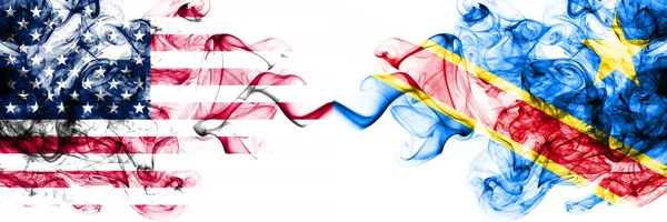 United States of America vs Democratic Republic of the Congo smoky mystic flags placed side by side. Thick colored silky abstract smokes banner of America and Democratic Republic of the Congo — 스톡 사진