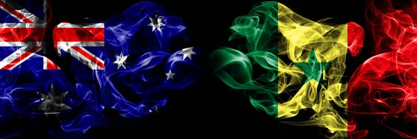 Australien, australiska, Senegal, senegalesiska rökiga mystiska flaggor placerade sida vid sida. Tjocka färgade silkeslena röker flagga koncept — Stockfoto