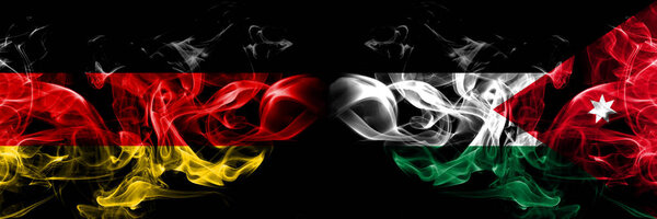 Germany, German, Jordan, Jordanian smoky mystical flags placed side by side. Thick colored silky smokes flag concept