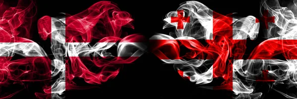 Danmark, Georgien konkurrens tjocka färgglada rökiga flaggor. Europeiska fotbolls kvalifikationer spel — Stockfoto