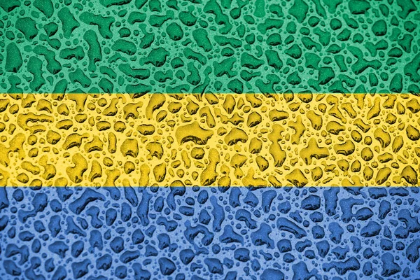 Gabonská národní vlajka byla vyrobena z poklesu vody. Koncepce předpovědí na pozadí. — Stock fotografie